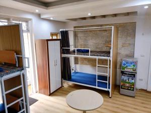 a room with two bunk beds and a table at 3BT home in Hanoi