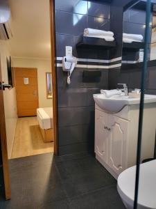 a bathroom with a sink and a toilet at Hotel Punta Rocas - Huacho in Huacho