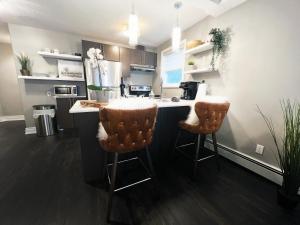 a kitchen with a counter and two bar stools at Stylish Boutique Studio in London