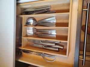 a drawer with silver utensils in a kitchen at The Cosmopolitan in Wortley Village in London