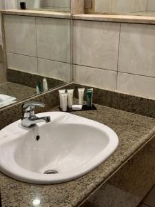 a bathroom counter with a white sink and a mirror at Villa Silia in Sharm El Sheikh