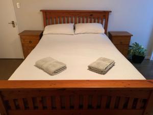 a bed with two towels on top of it at American Rustic Barn in Hamilton