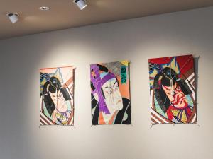a group of four paintings hanging on a wall at Vessel Inn Asakusa Tsukuba Express in Tokyo