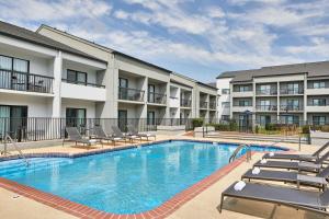 a swimming pool with lounge chairs and a building at Courtyard by Marriott Memphis Airport in Memphis