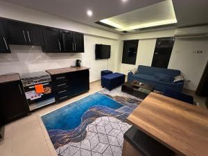 a living room with a blue couch and a kitchen at Villa Silia in Sharm El Sheikh