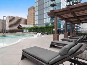 a swimming pool with lounge chairs in a building at Blue Luxe-Highrise, Balcony, Pool, City View! in Atlanta