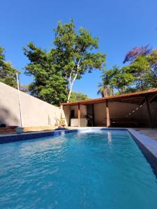 a swimming pool in front of a house at Casa do Fábio in Santana do Riacho