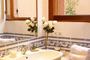 uma casa de banho com um lavatório e um vaso de flores em CASA MARINE DU SOLEIL 60 em Patrimonio