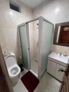 a bathroom with a shower and a toilet and a sink at Isa House - Private Rooms in a Shared Duplex in Praia +44 photos