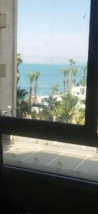 a view of the ocean from a window at סטודיו עם גקוזי ענק מול כינרת in Tiberias