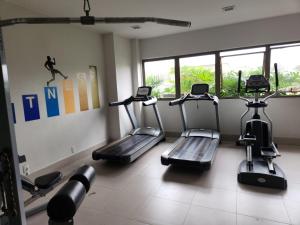 a gym with three tread machines in a room at Via Premiere Suíte 409 B in Rio de Janeiro