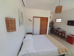 a bedroom with a large bed in a room at Flats Lages in Pôrto de Pedras +5 photos