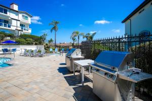 a patio with two bbqs and a grill at 2br Condo - Sleeps 6 - Garage - Wifi Laguna in Laguna Niguel