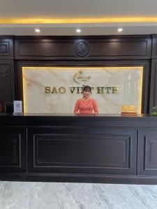 a woman is standing behind a display in a fireplace at Sao Việt HTH Hotel in Ha Long