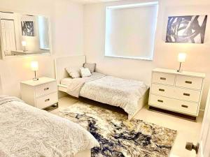 a bedroom with two beds and a mirror at Lovely 2/2 condo in Miami shores in Miami