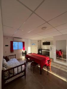 a living room with a red table and chairs at Delsa in Concordia