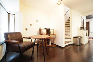 a living room with a table and a chair at ANGO KYOTO Ⅰ in Kyoto +18 photos