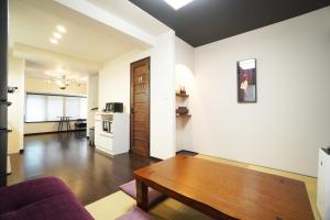 a living room with a couch and a table at ANGO KYOTO Ⅰ in Kyoto