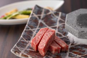 a plate of food with meat on a table at Biwafront Hikone in Hikone +9 photos