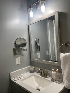 a bathroom with a sink and a large mirror at Downtown Home in Chattanooga in Chattanooga