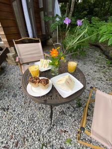 a table with two plates of food on it at Kebun Lisdtari Farmstay The Kabin in Air Hangat