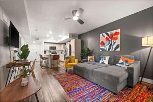a living room with a couch and a dining room at Sleek & Stylish Salt Lake City APT Prime Loc in Salt Lake City