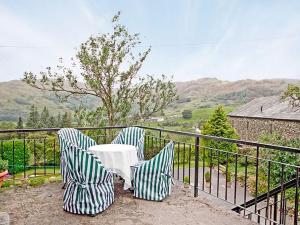 two chairs and a table sitting on a balcony at Garburn View in Kentmere