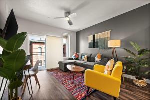 a living room with a couch and a yellow chair at Affordable APT in Salt Lake City Ideal Location in Salt Lake City