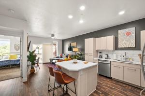 an open kitchen and living room with a counter and chairs at Affordable APT in Salt Lake City Ideal Location in Salt Lake City