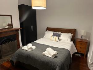a bedroom with a bed with two pillows on it at Glenelg House in Adelaide