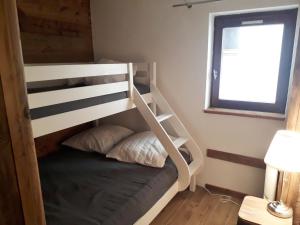 a bunk bed in a small room with a window at Appartement Morillon Village, 4 pièces, 7 personnes - FR-1-412-89 in Morillon