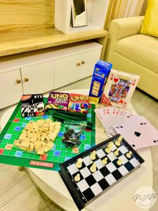 a table with a chess game and chips on it at Homestay by ViJiTa 2bedroom condo in Manila