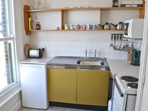 a kitchen with a sink and a stove at Sky Lark in Cromer