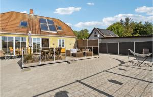 a patio with chairs and a house at Cozy Home In Egernsund With Wifi in Egernsund