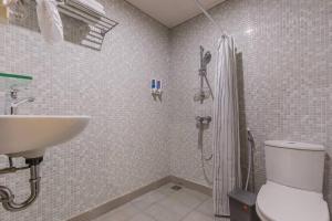 a bathroom with a sink and a shower and a toilet at Victoria Villa Seminyak in Seminyak +13 photos