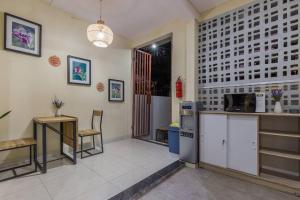 a room with a kitchen with a counter and a table at Victoria Villa Seminyak in Seminyak