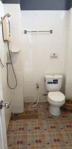 a bathroom with a toilet and a shower at Moon Travel Phangan in Ban Nua