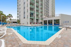 a swimming pool in front of a building at Ocean Park Resort 1222 in Myrtle Beach
