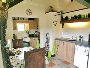 a kitchen with a table and a counter top at The Bothy in Malvern Wells