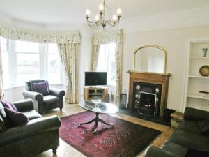 a living room with a couch and a fireplace at The Dell in Fort Augustus