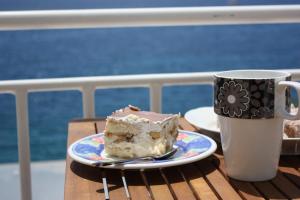 a piece of cake on a plate next to a coffee mug at Studio Apartment Lenka in Milna
