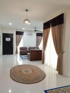 a living room with a couch and a rug at Juniper Homestay Putrajaya Presint 11 in Putrajaya