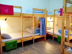 a room with three bunk beds in a hostel at N-square Hostel 任意宿背包客棧 in Yuanli