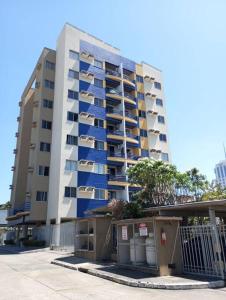 a tall apartment building with blue balconies on it at Sinta-se em casa! Lindo Ap para você e sua família in Manaus