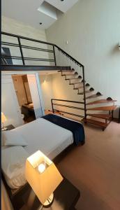 a bedroom with a bed and a stair case at Giakor Suites - Gran Jardín in León