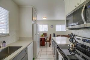 a kitchen with a sink and a stove top oven at Oceanbreeze - newly remodeled delightful oasis in the heart of Mission Beach, sleeps 6 in San Diego