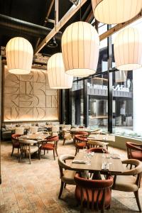 a restaurant with tables and chairs and chandeliers at The Interlude in Melbourne