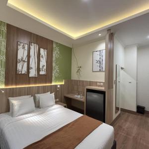 Postel nebo postele na pokoji v ubytování D'Bamboo Suites