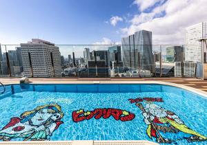 a large swimming pool on the roof of a building at APA Hotel & Resort Osaka Umeda Eki Tower in Osaka