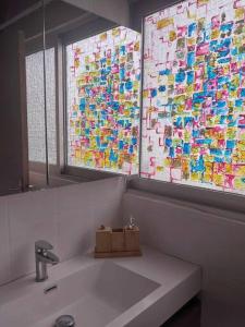 baño con lavabo, ventana y espejo en Leili Home - Papeete, en Papeete
